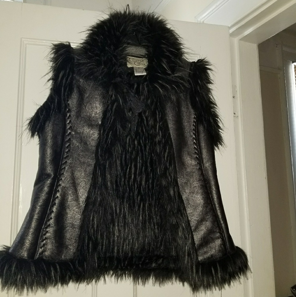 A very stylish black vest with faux fur